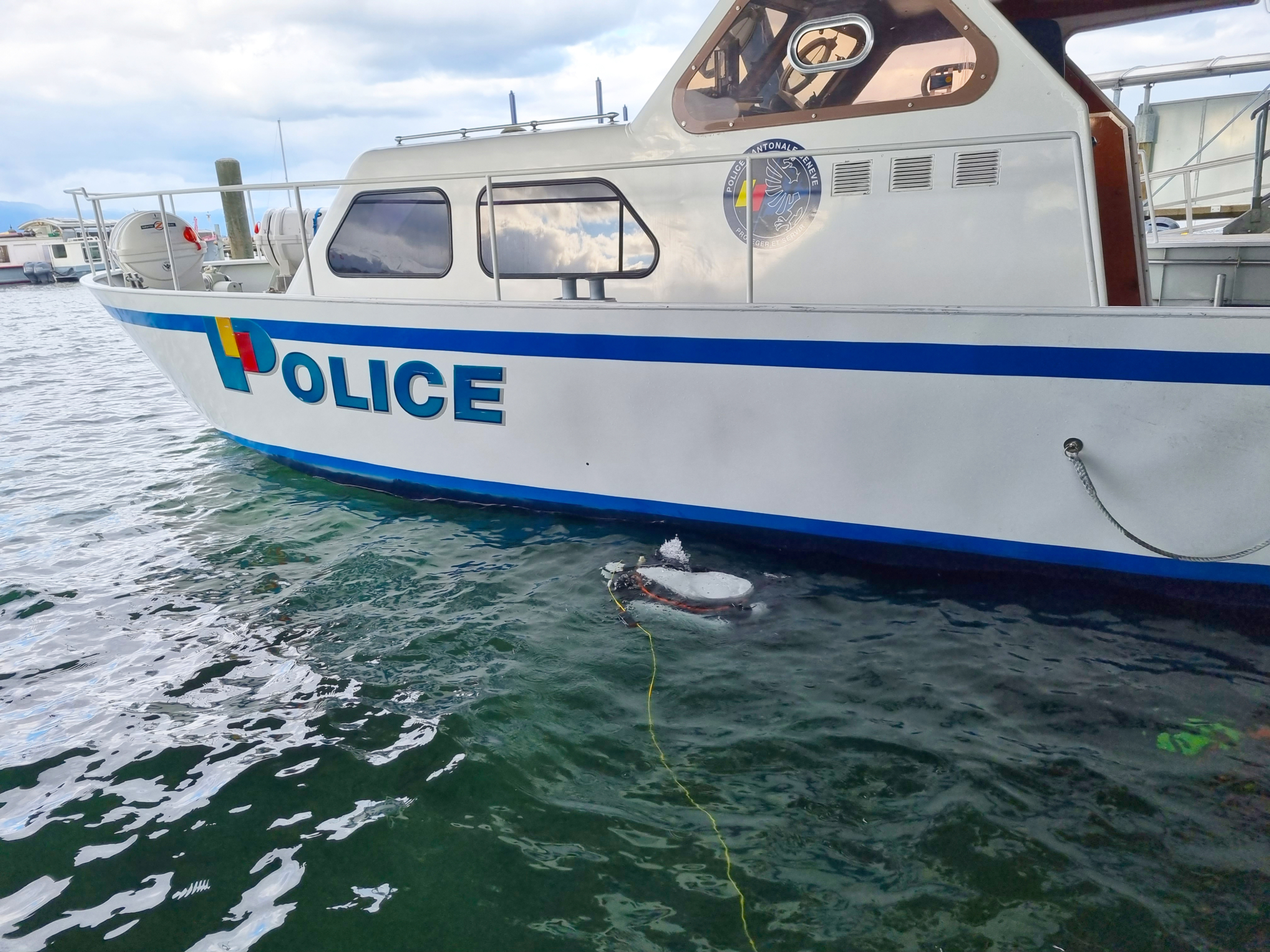 DVL robot besides police boat
